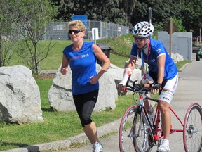 Premier Kathleen Wynne jogs with paracyclist Shelley Gauthier on Aug. 14, 2014 at Ontario Place to draw attention to the 2015 Pan and Parapan American Games. (Antonella Artuso/Toronto Sun)
