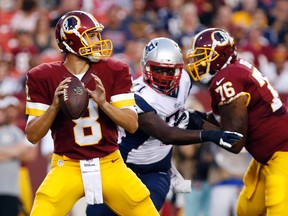 Washington Redskins quarterback Kirk Cousins (8) throws the ball as New England Patriots offensive tackle Cameron Fleming (71) chases in the first quarter at FedEx Field. (Geoff Burke-USA TODAY Sports)