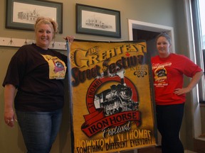 Iron Horse Festival events coordinator Rebekah Ryersee, left, and vendor coordinator Victoria Ilic hold a poster for the festival, which returns to St. Thomas Aug. 21-24. Ben Forrest/Times-Journal