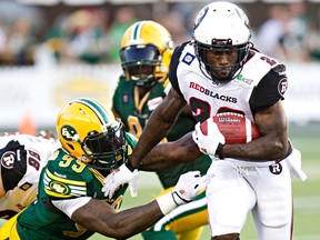 Edmonton's Gregory Alexandre (95) tries to tackle Ottawa's Chevon Walker (29) during the first half of the Eskimos-RedBlacks game at Commonwealth Stadium in Edmonton July 11. The Eskimos won the game 27-11. The rematch is Friday night at TD Place. (Codie McLachlan/Edmonton Sun/QMI Agency)