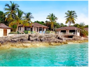 Exterior of the Point House, owned by billionaire hedge fund manager Louis Bacon, and now up for sale for $35 million US. The posh Bahamas home is located on Lyford Cay, next door to Canadian fashion mogul Peter Nygard, with whom Bacon has feuded for years.  (lyfordcayhomes.com)