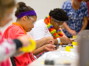 Mecheala Campbell-Pennant, 13, pieces together a circuit board while building a robot at the Girls' Technology Camp at Fanshawe College in London. 
CRAIG GLOVER/The London Free Press/QMI Agency