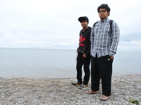 Toronto friends Ashif Ahmed, 18, (L) and Tashpi Rahman, 19, pictured Thursday, August 14, 2014, near the R.S. Harris Harris Water Filtration plant in the east end of the Toronto Beach area where they set off in a dinghy Wednesday. (Jack Boland/Toronto Sun)