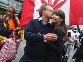 "Prince of Pot" Marc Emery (L) with wife Jodie on Thursday, August 14, 2014 at Yonge Dundas Square speaking to like-minded cannabis culture friends after his recent release from a five-year term in the U.S. penal system. (Jack Boland/Toronto Sun)