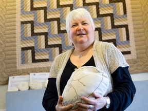 Midwife Kathi Wilson stands near an Amish quilt which hangs in the Thames Valley Midwives office on Maitland Street in London, Ontario on Thursday August 14, 2014.  Wilson, who works closely with area Amish communities, has started a blog about her experiences to lift the curtain and expose misconceptions about the closed society.
CRAIG GLOVER/The London Free Press/QMI Agency