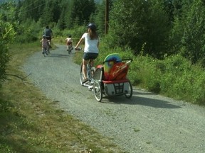 Here's a family out for a lovely outing ... and they're about to ignore warning signs forbidding their entry into the territory of an aggressive bear near Canmore's Quarry Lake.
Photo courtesy Alberta Justice