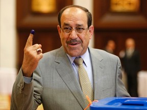 Iraq's Prime Minister Nuri al-Maliki shows his ink marked finger as he votes during parliamentary election in Baghdad in this April 30, 2014 file photo. 
 REUTERS/Ahmed Jadallah/Files