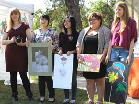 Five Gallery in the Grove scholarship winners pose with some of their works of art in Bright's Grove on August 13. From left to right (with univeristy/college they are attending in brackets), Emily Hussey (Lambton College), Alice Kwon (Sheridan College), Sharon Yi (York University), Julie Downie (Algoma University) and Danielle Timmers (Georgian College). CARL HNATYSHYN/SARNIA THIS WEEK/QMI AGENCY