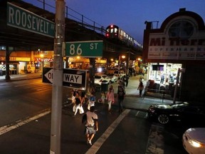 People make their way on the streets of the neighborhood of Queens in New York August 8, 2014. Reuters/Eduardo Munoz