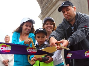 Natalie Miropolsky, her husband Dmitri and their children Nicole and Dennis cut the ribbon during the opening ceremonies of the CNE in Toronto on Friday August 15, 2014. (DAVE ABEL/Toronto Sun)