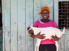 Daisy Barengetuny with one of the goats purchased by her expanding business. (Photo Credit: Matt Finlin)