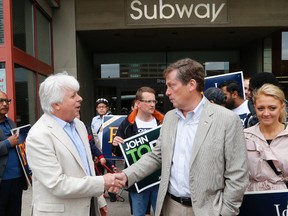 Councillor John Filion shakes hand with mayoral candidate John Tory on Aug. 16, 2014 in front of the Sheppard subway station. (Michael Peake/Toronto Sun)