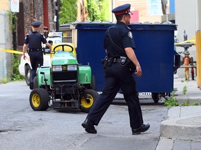 Toronto Police on scene near Sherbourne and Front Sts. in Toronto after a man was crushed while moving a dumpster on Aug. 15, 2014. (Dave Abel/Toronto Sun)