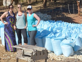 Lambton College students Amanda da Silva, Erica Chisholm and Ally Bell inspect the corn harvest at a Kasaka region farm in May. A total of 144 Zambian farmers participated this year in the One Seed Project, an innovative agricultural program established by Enactus Lambton and Southwest Ag Partners. SUBMITTED PHOTO