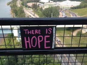 A homemade sign displayed on the High Level Bridge on Aug. 15, 2014, letting potential suicide victims know "There is Hope" includes phone numbers to crisis relief centres. DAVID BLOOM/EDMONTON SUN/QMI AGENCY