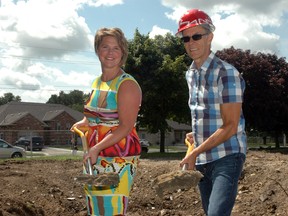 Patricia Riddell-Laemers, executive director of the St. Thomas Early Learning Centre, and Rev. Peter Barbour of Aylmer Full Gospel Church, grip shovels behind the church on Friday afternoon. Both attended the ceremonial ground breaking of an addition to the church that will house Early Learning Centre programming. 

Ben Forrest/Times-Journal

(Photo taken Friday, Aug. 15, 2014)