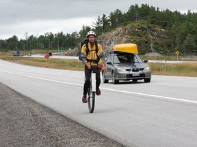 JOHN LAPPA/THE SUDBURY STAR/QMI AGENCYJoseph Boutilier, of Victoria, BC, travels on a unicycle on Highway 69 South near Estaire, ON. on Thursday, August 14, 2014. Boutilier is travelling across Canada to raise awareness about climate change and to make climate change an election issue during the 2015 federal election. He started his journey on April 5, 2014 in Victoria, and he hopes to arrive in Ottawa on Sept. 16.