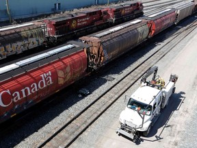 Canadian Pacific Railway crews drive past trains at the CP Rail yards in Calgary, Alberta, April 29, 2014. REUTERS/Todd Korol