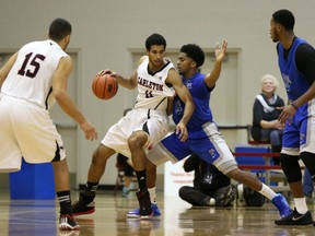 Carleton's Thomas Scrubb tries to drive to the net against University of Memphis guard Pookie Powell Saturday night at the Ravens' Nest. (Chris Hofley/Ottawa Sun)