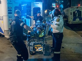 EMS transport a male after a stabbing at Peter and Adelaide Sts. early Sunday, Aug. 17, 2014. (Victor Biro photo)