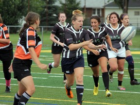 Sarnia Saints co-captain Jamie Holmes passes a ball off to a teammate during their game against the St. Catharines Tigers at Norm Perry Park on Saturday, August 16. The Saints defeated St. Catharines by a score of 45-0, securing 1st place in the Niagara Rugby Union with one week left in the season. SHAUN BISSON/THE OBSERVER/QMI AGENCY