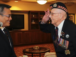 Ninety-three-year-old Second World War veteran William Ralph Webb is presented the Battle of Normandy 70th anniversary medallion by Kingston and the Islands MP Ted Hsu on Saturday at the Waterford Retirement Residences. Webb was unable to attend the official ceremony in France this past June due to his health. He is also celebrating his 70th wedding anniversary with family and friends. (Julia McKay/The Whig-Standard)