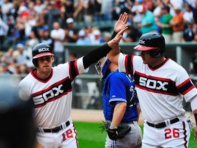 Chicago White Sox third baseman Conor Gillaspie (12) is greeted by right fielder Avisail Garcia (26) after hitting a grand slam home against the Toronto Blue Jays during the first inning at U.S Cellular Field. (David Banks-USA TODAY Sports)