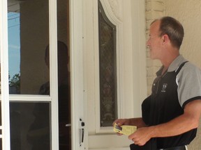Shawn Dobson, candidate for city councillor in St. Charles ward, knocks on doors as part of his campaigning, Aug. 13, 2014. (JIM BENDER/Winnipeg Sun)