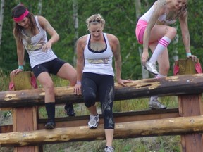 Ryan Byrne/For The Sudbury Star    
Particpants clambered over rustic fences as part of the Dirty Divas cancer fundraiser on Saturday.