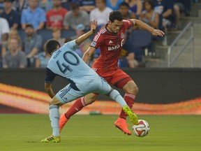 Toronto FC forward Gilberto passes the ball as Sporting KC’s Igor Juliao defends on Saturday night. TFC lost the game 4-1. (USA Today Sports)
