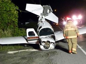 Fire Department investigators look at the wreckage of downed six-passenger civilain aircraft. The pilot was the only one in the plane and was taken to Trenton Memorial Hospital. Reports from the scene say the pilot avoided a crash landing in the Bay of Quinte just a few metres to the south. The crash occurred shortly after 9 p.m. Sunday, August. 17, 2014 in Trenton, Ont. A section of the Loyalist Parkway (Hwy. 33) remains closed. Transportation safety board inspectors were on their way to the scene Sunday. Ernst Kuglin/The Intelligencer/QMI Agency