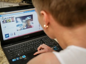 A young man eyes his own Facebook page in his home near Fish Creek Park in Calgary, Alta., on Sunday, Aug. 17, 2014.
He claims his dad's BMW X5 was stolen and that when it was recovered a previously unknown camera was also inside with photos of two people posing beside what looks to be the same car.
Lyle Aspinall/Calgary Sun/QMI Agency