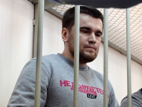 A file picture taken on April 24, 2014 shows opposition activist Alexei Gaskarov, one of the anti-Putin protesters accused of instigating mass riots at Bolotnaya square, standing inside the defendant cage in Zamoskvoretsky district court in Moscow, during his trial. (AFP PHOTO/VASILY MAXIMOV)