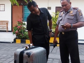 Police examine the suitcase in which the body of Sheila von Wiese-Mack was found, at a police station in Nusa Dua, on the Indonesian holiday island of Bali Aug. 12, 2014. REUTERS/Komang Ernii