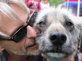 Doug Simpson with his foster dog Buddy, that he adopted from the All Breed Canine Rescue Group out of St. Thomas and London. Hundreds of pet owners, and dogs of all shades and sizes from around Middlesex County and other areas came to Pawlooza in London August 15, also National Homeless Animals' Day.