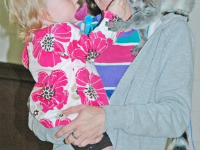 Jocelyn Bremner-Hunt feeds a ring-tailed lemur as her mom Angela looks on during a presentation by Jungle Cat World at the Mitchell & District Community Centre last Thursday evening, Aug. 14. KRISTINE JEAN/MITCHELL ADVOCATE