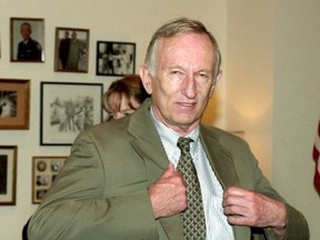 Former U.S. senator James Jeffords is helped with his suit coat as he prepares to meet Vermont constituents in his Capitol Hill Office in Washington, in this June 5, 2001 file photo. (REUTERS/Files)