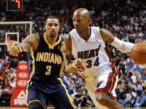 Miami Heat guard Ray Allen (34) drives to the basket as Indiana Pacers guard George Hill (3) defends during the first half at American Airlines Arena on Apr 11, 2014 in Miami, FL, USA. (Steve Mitchell/USA TODAY Sports)