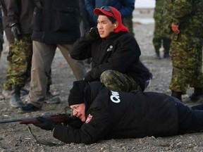 Prime Minister Stephen Harper (bottom) shoots a .303 Lee-Enfield rifle while taking part in a demonstration by the Canadian Rangers at a camp near the Arctic community of Gjoa Haven, Nunavut August 20, 2013. REUTERS/Chris Wattie