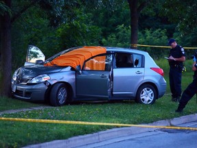 Toronto Police secure the scene at Eglinton Ave. W. and Jane St. after a fatal double shooting in Toronto on Monday, August 18, 2014. (Dave Abel/Toronto Sun)