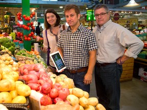Margaret Milczarek, Jason Gilliland and David Corke find Ontario produce in Covent Garden Market using their local food app. (MIKE HENSEN, The London Free Press)