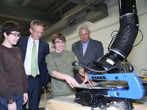 JOHN LAPPA/THE SUDBURY STAR
Cambrian College electrical engineering technology students Bianca Coles, left, and David Guillemette, second right, show Cambrian College president Bill Best, second left, and Sault Ste. Marie MP Bryan Hayes a project they are working on in a research lab at the Glencore Centre for Innovation at Cambrian College on Monday.
