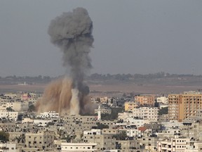 Smoke rises following what witnesses said was an Israeli air strike in Gaza August 19, 2014. (REUTERS/Ahmed Zakot)