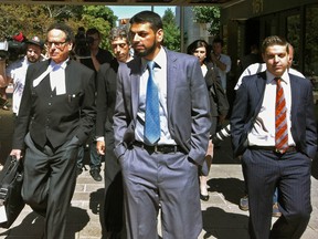 Dr. Khurram Sher walks outside the Ottawa Courthouse after being acquitted of terror conspiracy charges. At left is his lawyer, Michael Edelson. (TONY SPEARS Ottawa Sun)