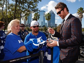 Ryan Malone of the Tampa Bay Lightning signs autographs as he arrives for the team's home opening game against the Florida Panthers at the Tampa Bay Times Forum on October 10, 2013. (Mike Carlson/Getty Images/AFP)
