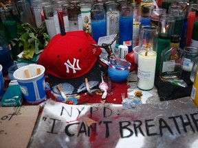 Candles are seen at the memorial of Eric Garner in Staten Island, New York, July 21, 2014. REUTERS/Eduardo Munoz