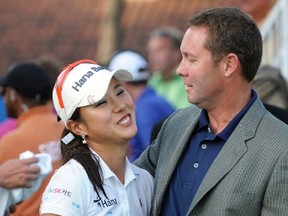 Park Hee-Young of South Korea is congratulated by LPGA Commissioner Michael Whan after winning the CME Group Titleholders LPGA golf tournament in Orlando, Florida in this November 20, 2011 file photo. (REUTERS/Phelan Ebenhack/Files)