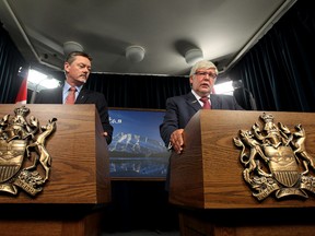 left to right) President of Treasury Board and Minister of Finance Doug Horner and Premier Dave Hancock respond to the recent Auditor General's report, during a press conference at the Alberta Legislature, in Edmonton Alta., on Tuesday Aug. 19, 2014. David Bloom/Edmonton Sun