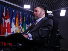Conservative Member of Parliament Steven Fletcher waits to leave following a news conference regarding his two private member's bills dealing with physician-assisted suicide, on Parliament Hill in Ottawa March 27, 2014. (REUTERS/Chris Wattie)