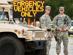 Missouri National Guard soldiers stand by at a police command post in Ferguson, Missouri August 19, 2014.    REUTERS/Mark Kauzlarich